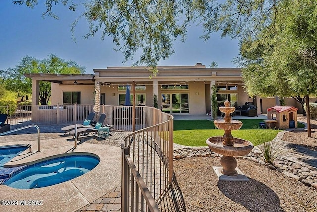 back of house with a patio area and a hot tub