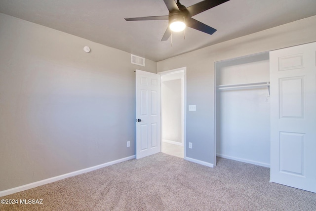 unfurnished bedroom featuring ceiling fan, a closet, and carpet