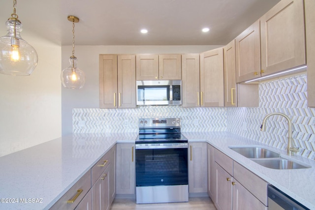 kitchen with decorative backsplash, stainless steel appliances, sink, light brown cabinets, and decorative light fixtures