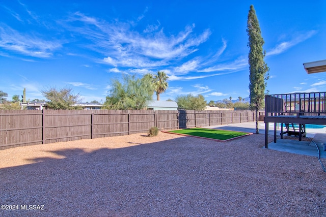 view of yard with a patio area and a wooden deck