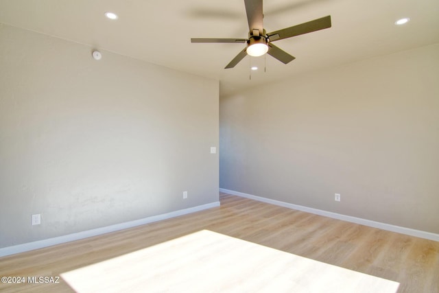 empty room featuring light hardwood / wood-style flooring and ceiling fan