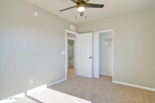 unfurnished bedroom featuring a closet, light colored carpet, and ceiling fan