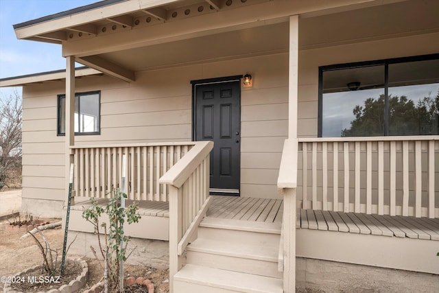 view of exterior entry featuring a porch