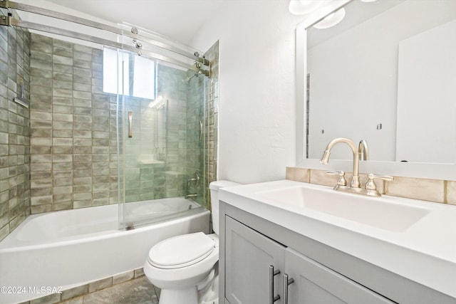 full bathroom with combined bath / shower with glass door, vanity, and toilet