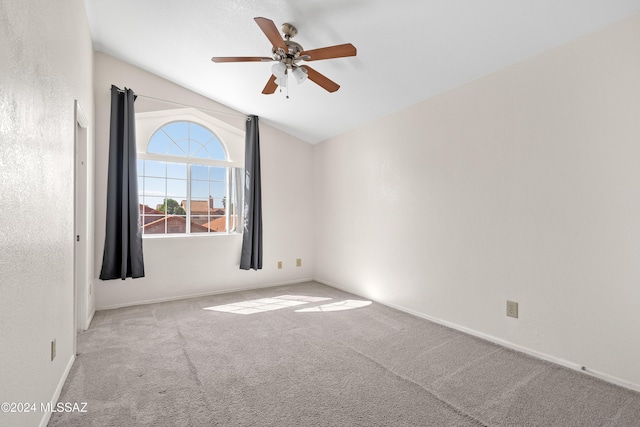 unfurnished room featuring ceiling fan, light colored carpet, and lofted ceiling