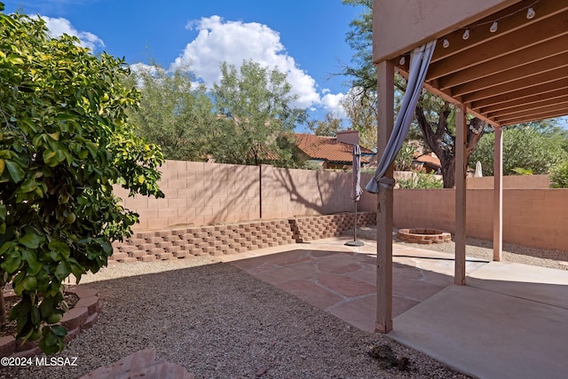 view of patio with a fire pit