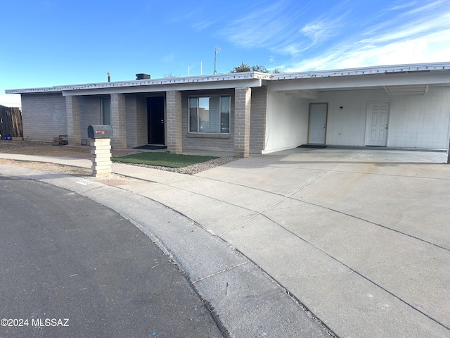 single story home with a carport