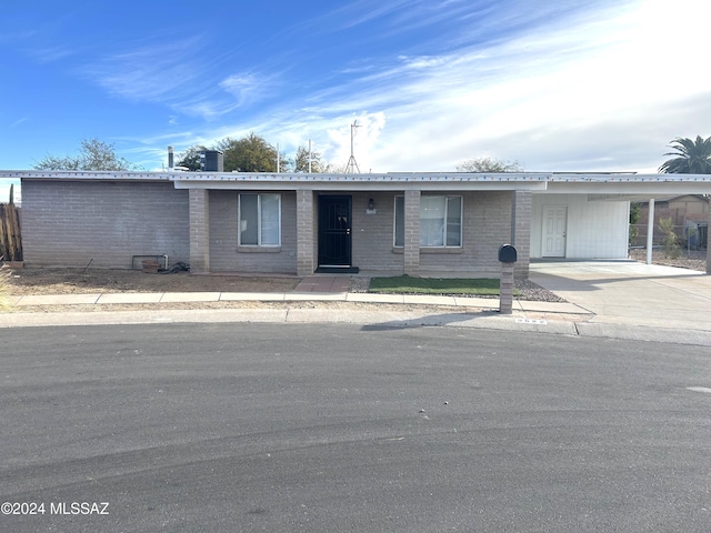 single story home featuring a carport