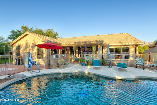 view of swimming pool with a patio area