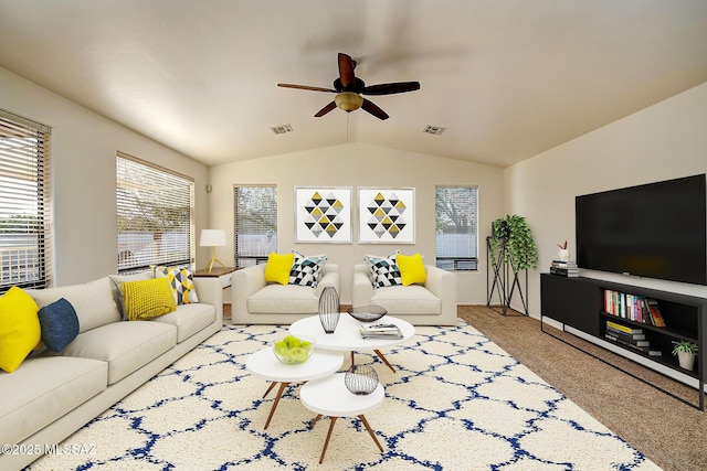 living room with ceiling fan, carpet floors, and vaulted ceiling