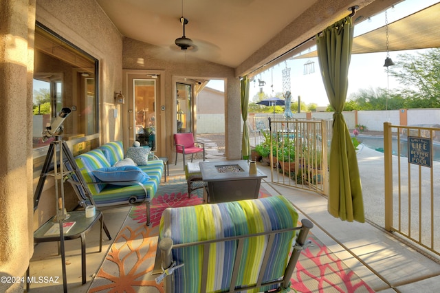 view of patio featuring ceiling fan, a fenced in pool, and an outdoor living space with a fire pit