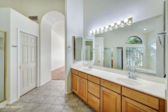 bathroom featuring separate shower and tub, tile patterned flooring, and vanity