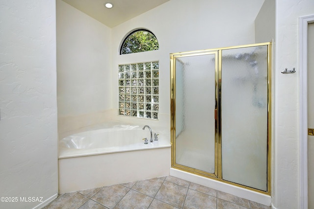 bathroom with plus walk in shower, tile patterned floors, and lofted ceiling