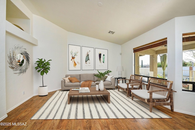 sitting room featuring hardwood / wood-style flooring and vaulted ceiling