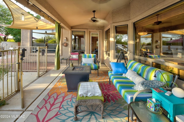 view of patio featuring an outdoor living space with a fire pit and ceiling fan