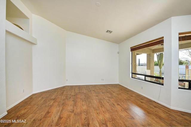 spare room with wood-type flooring