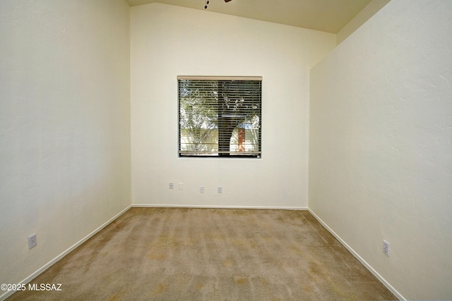 unfurnished room with light carpet and vaulted ceiling