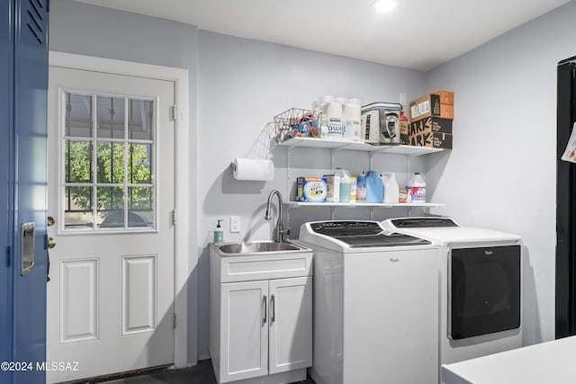 laundry area with sink, cabinets, and independent washer and dryer