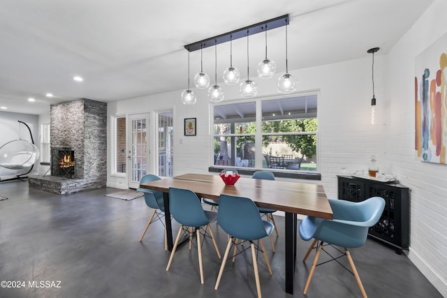 dining space with a stone fireplace