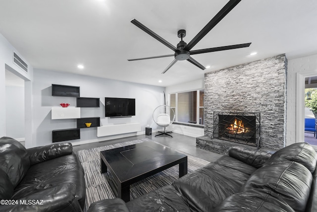 living room with a fireplace and ceiling fan