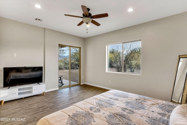 bedroom with access to outside, ceiling fan, and hardwood / wood-style flooring