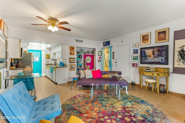 living room with ceiling fan and light tile patterned flooring