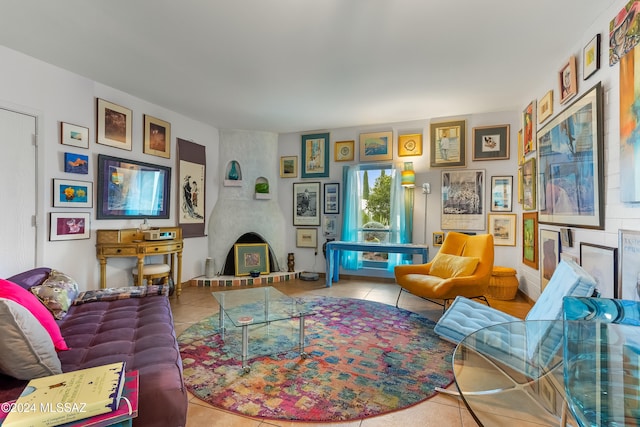 tiled living room featuring a fireplace