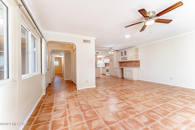 unfurnished living room featuring ceiling fan, light tile patterned floors, and crown molding