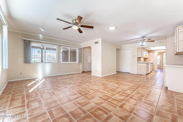 unfurnished living room with crown molding, sink, and ceiling fan