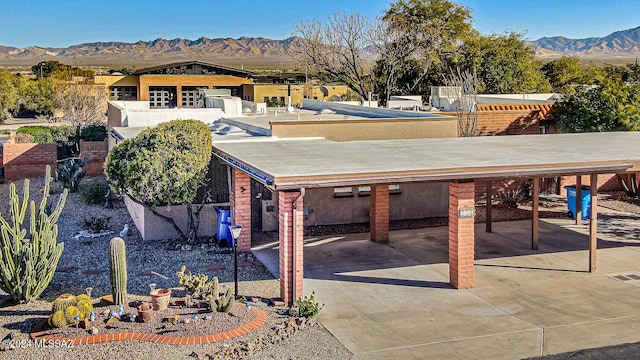 exterior space with a mountain view and a patio