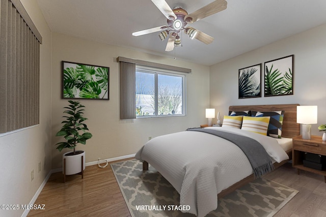 bedroom with ceiling fan, a closet, and hardwood / wood-style flooring