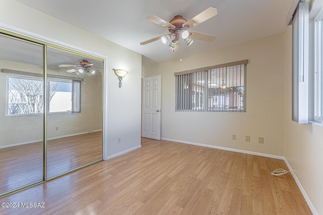 unfurnished bedroom featuring ceiling fan, light hardwood / wood-style flooring, and a closet