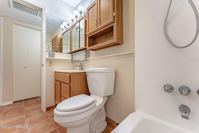 bathroom featuring tile patterned flooring, vanity, and toilet