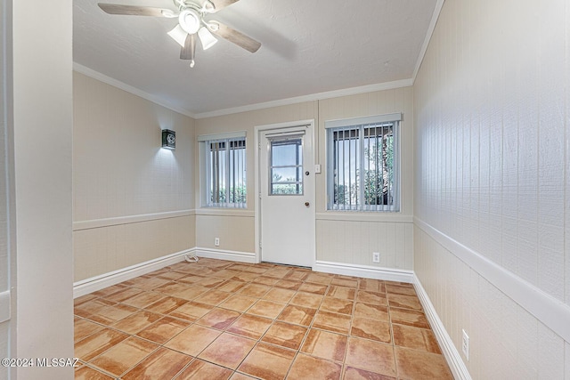 unfurnished room featuring ceiling fan and crown molding