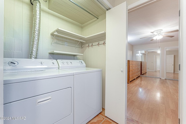 laundry room featuring washing machine and clothes dryer, ceiling fan, and light hardwood / wood-style floors