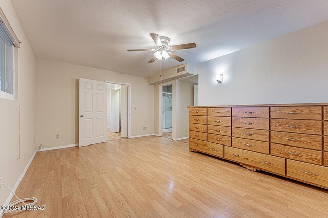 unfurnished bedroom featuring a textured ceiling, light hardwood / wood-style flooring, and ceiling fan