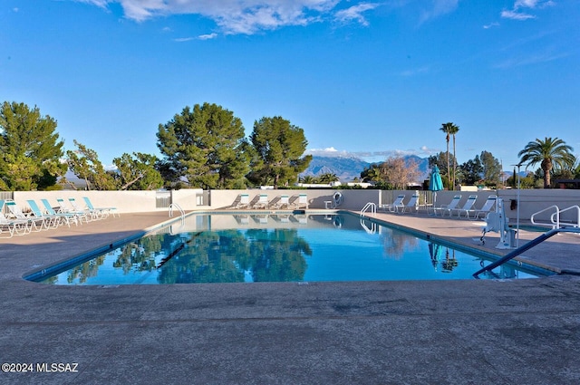 view of swimming pool with a mountain view and a patio