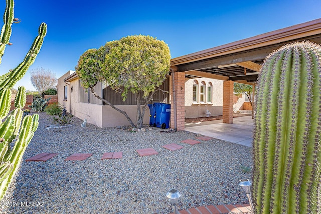 view of side of home with a patio area