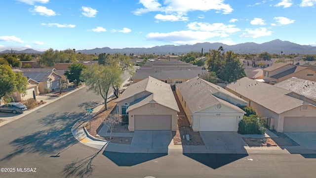 birds eye view of property featuring a mountain view