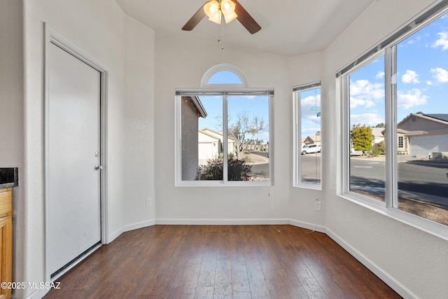 unfurnished sunroom featuring a wealth of natural light and ceiling fan