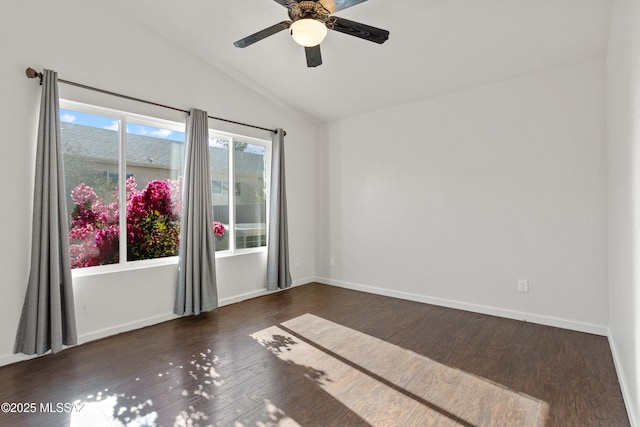 empty room featuring lofted ceiling, dark wood-type flooring, and ceiling fan