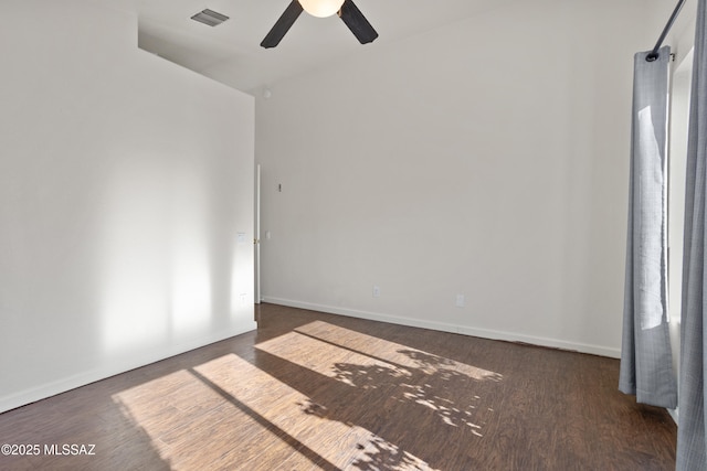 spare room featuring dark hardwood / wood-style floors and ceiling fan