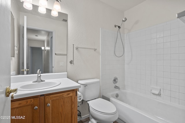 full bathroom featuring vanity, toilet, and tiled shower / bath combo