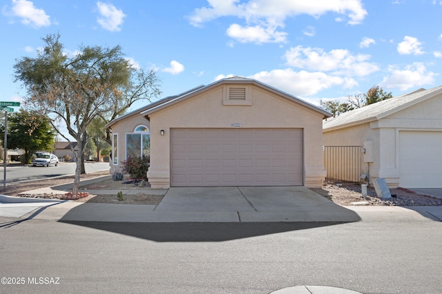 single story home with a garage and an outbuilding