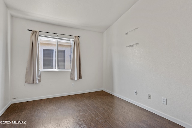 unfurnished room featuring dark hardwood / wood-style floors