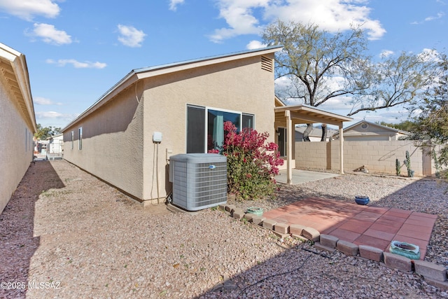 rear view of property with a patio and central AC