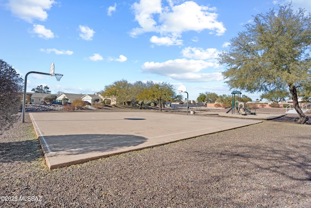 view of basketball court featuring a playground