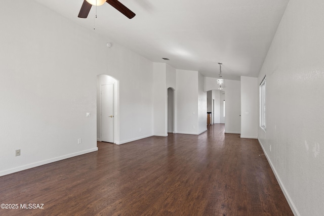 unfurnished living room featuring ceiling fan and dark hardwood / wood-style flooring