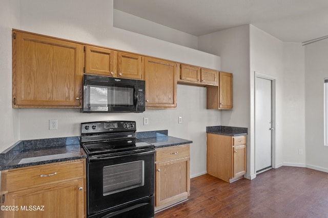 kitchen featuring dark stone counters, dark hardwood / wood-style floors, and black appliances