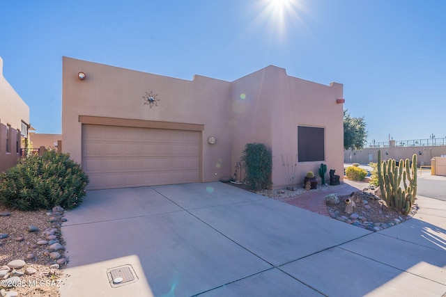 pueblo revival-style home with a garage